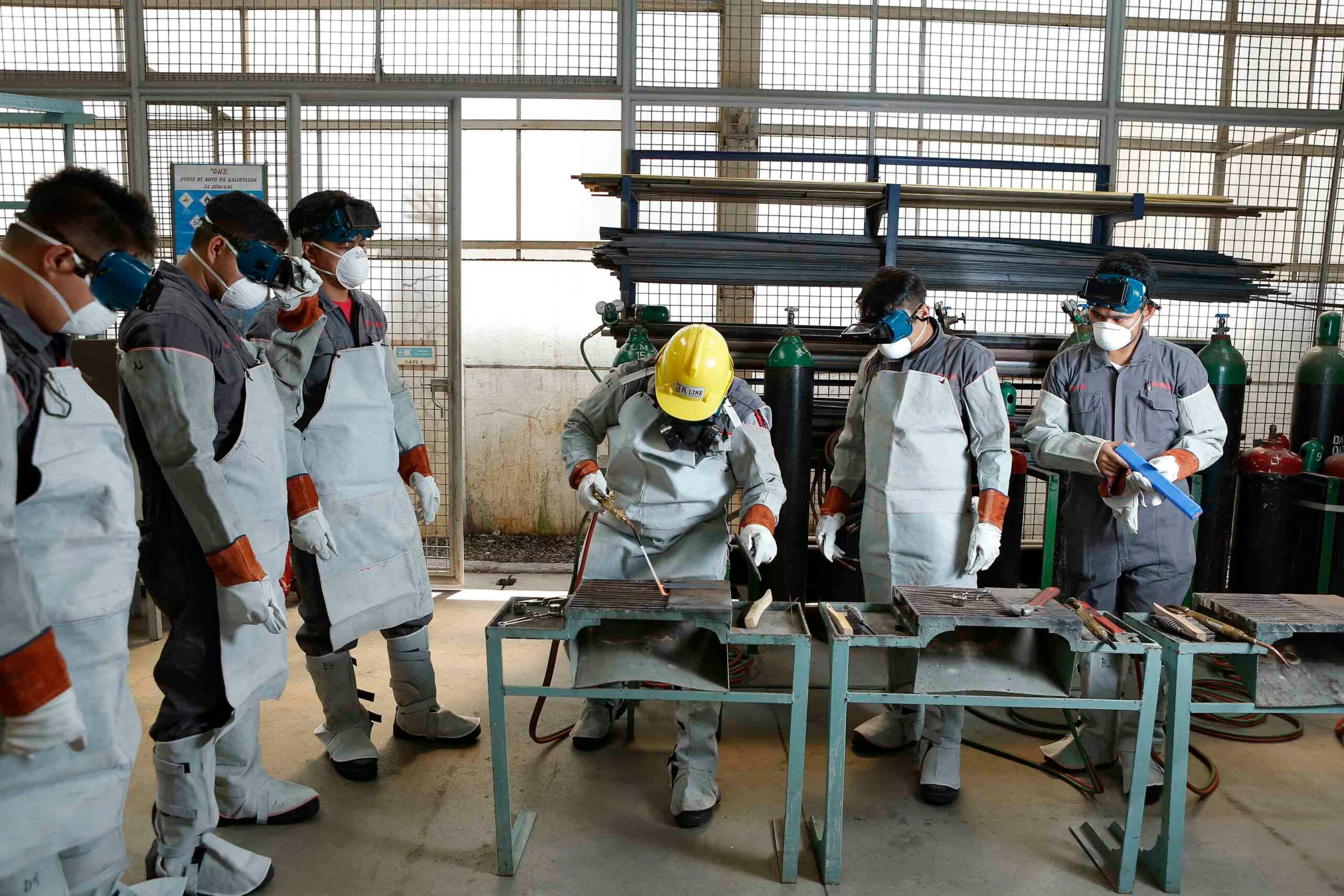 Group of workers in full PPE attending a gas welding training session