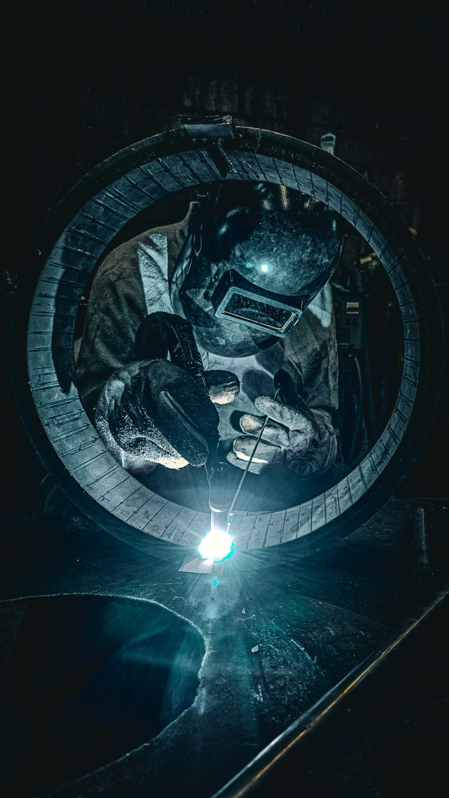 Workers in full PPE training on welding exercises at benches